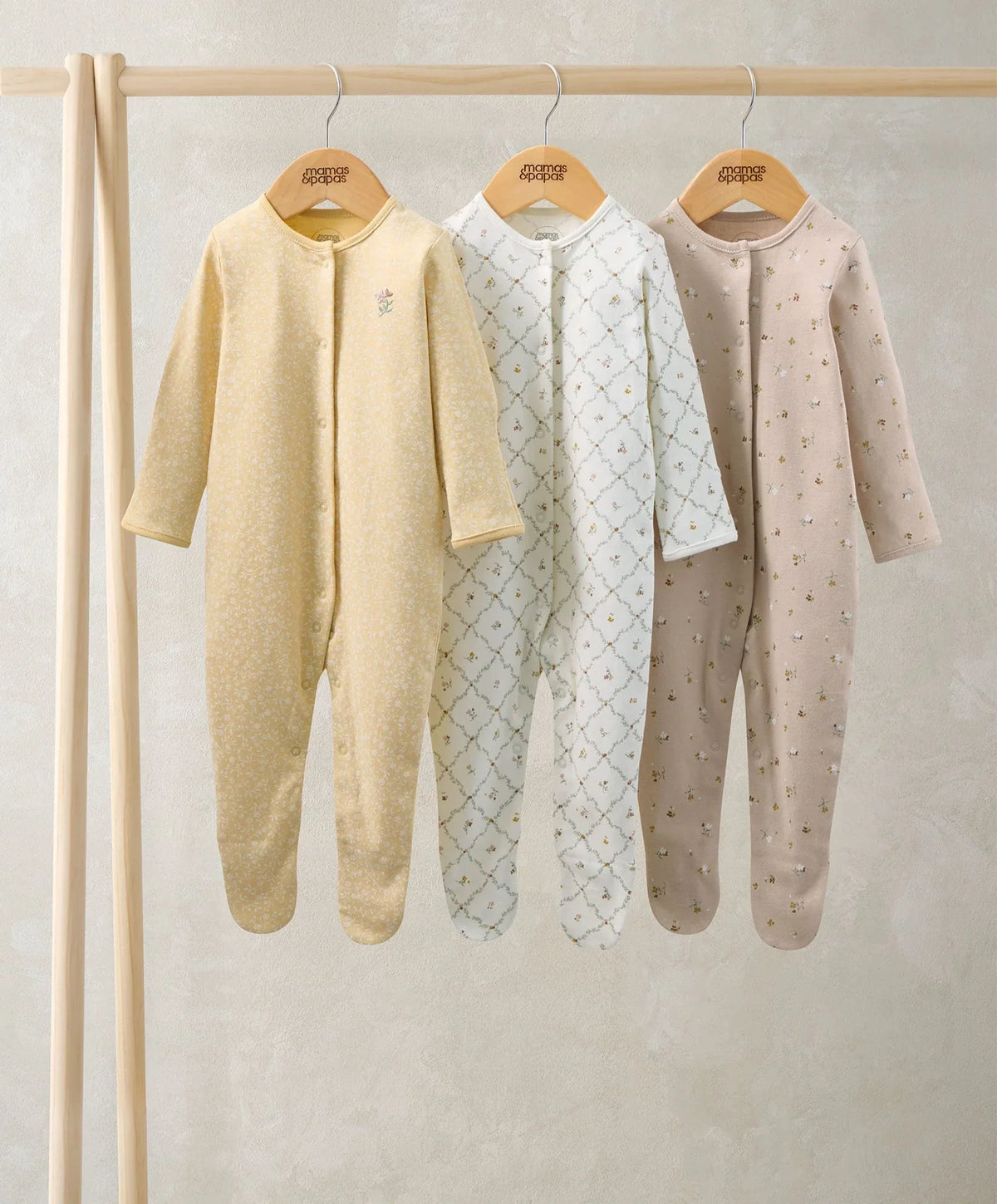 3 floral sleepsuits: yellow solid, white patterned, taupe small dots