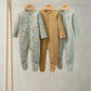 Pack of 3 baby sleepsuits hanging: light blue sea print, tan dots, mint solid