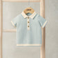 Light blue jacquard knitted polo shirt with cream collar and button placket