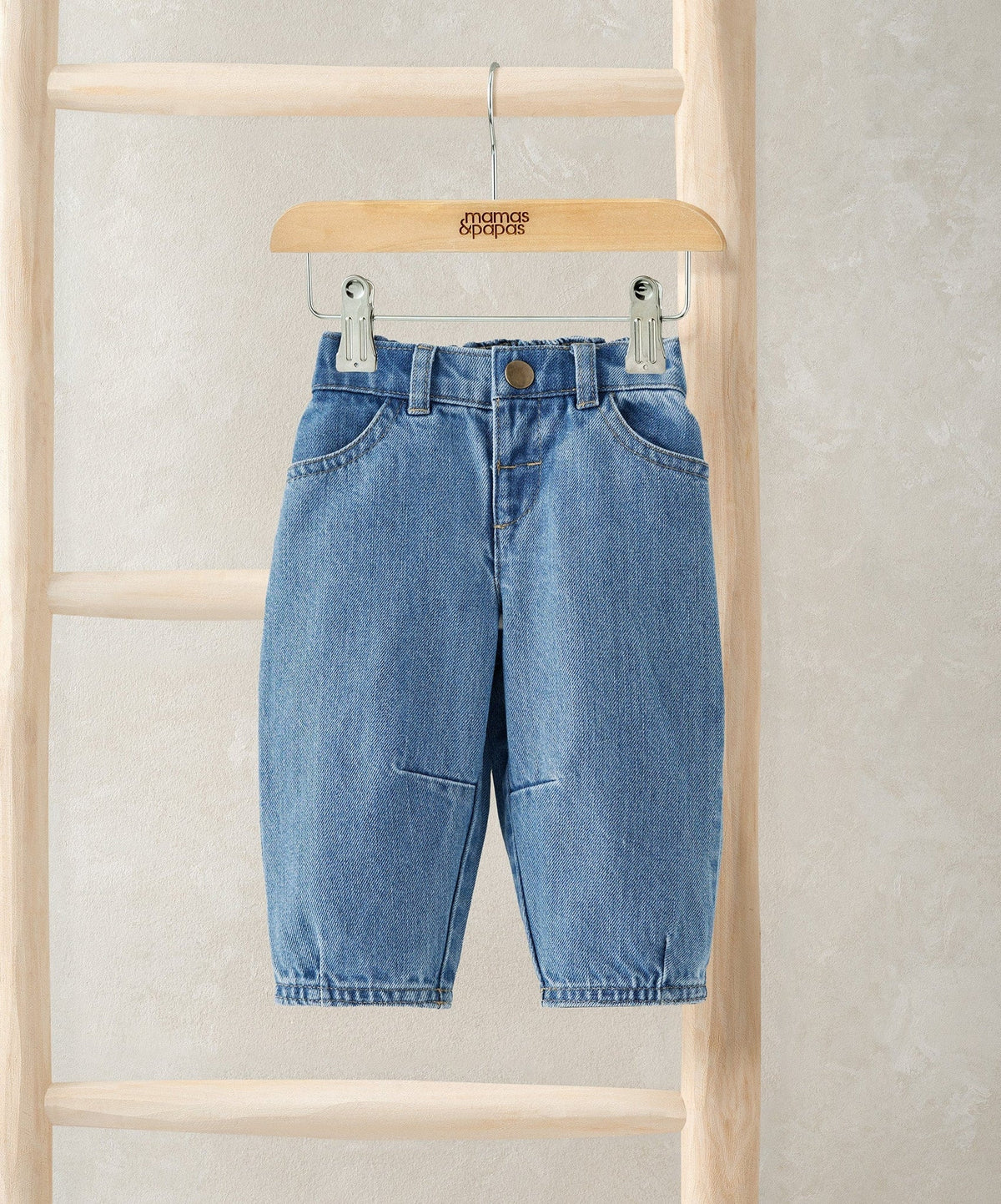 Light blue barrel-leg jeans with button fly and belt loops