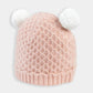 Pink textured knit beanie hat with two white pom poms