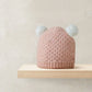 Pink knit pom pom beanie hat with two white pom poms