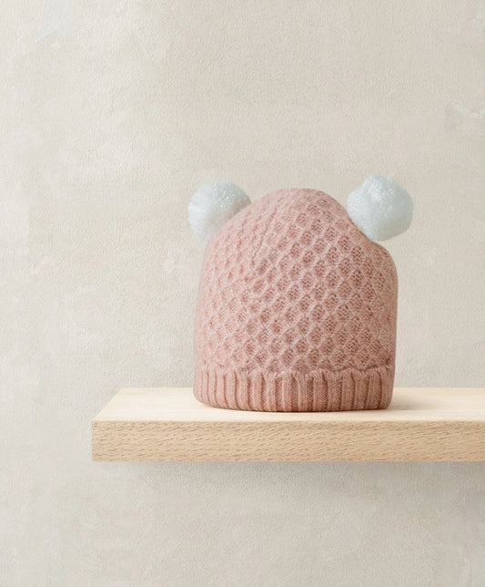 Pink knit pom pom beanie hat with two white pom poms