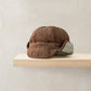 Brown trapper hat with ribbed knit texture and gray faux-fur earflaps