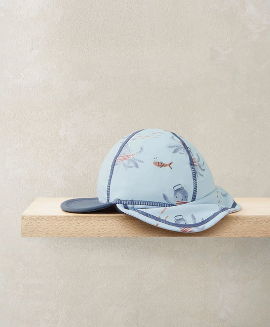 Squid print swim cap, light blue with navy brim and side flap, orange and gray squid