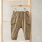 Tan utility joggers with drawstring waist and cargo pockets at the thighs