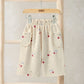 Kids joggers in off-white with red cherry print, elastic waistband and side pockets