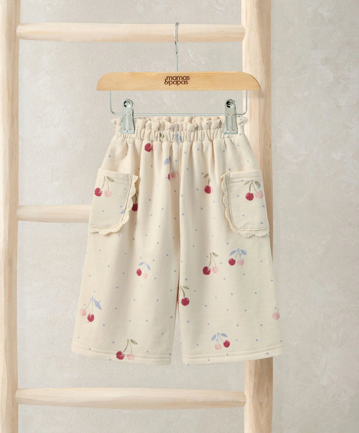 Kids joggers in off-white with red cherry print, elastic waistband and side pockets