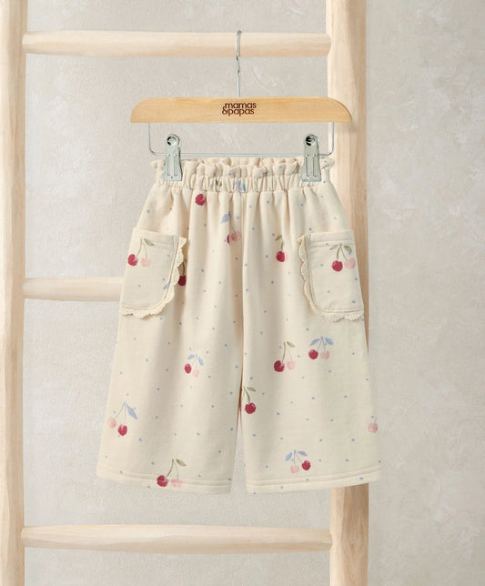 Kids joggers in off-white with red cherry print, elastic waistband and side pockets