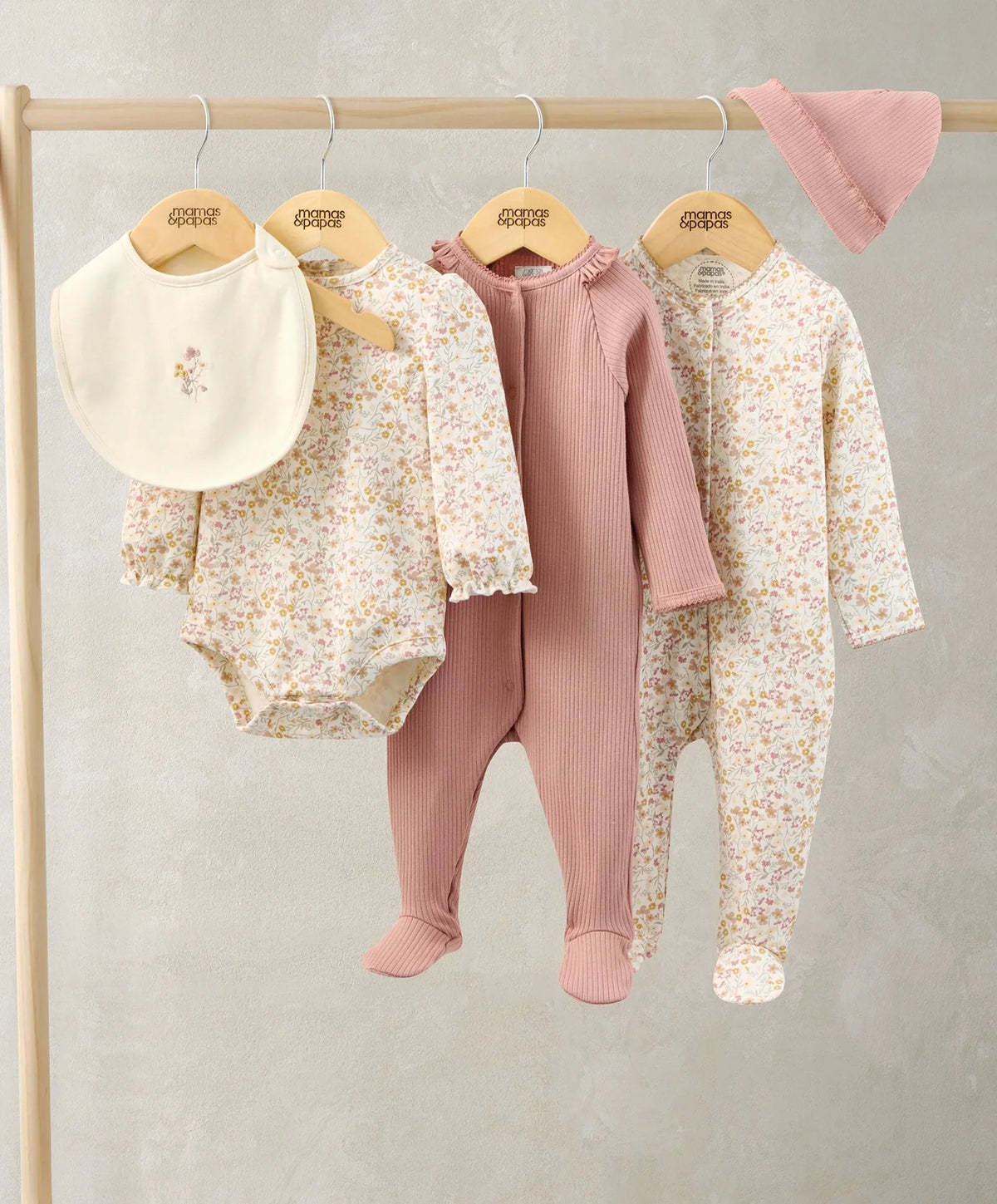 5-piece baby clothes set: floral footed pajamas, ribbed mauve pants, pink hat, bib