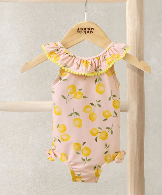 Pink lemon-print frill swimsuit with ruffled pom neckline and side bow ties