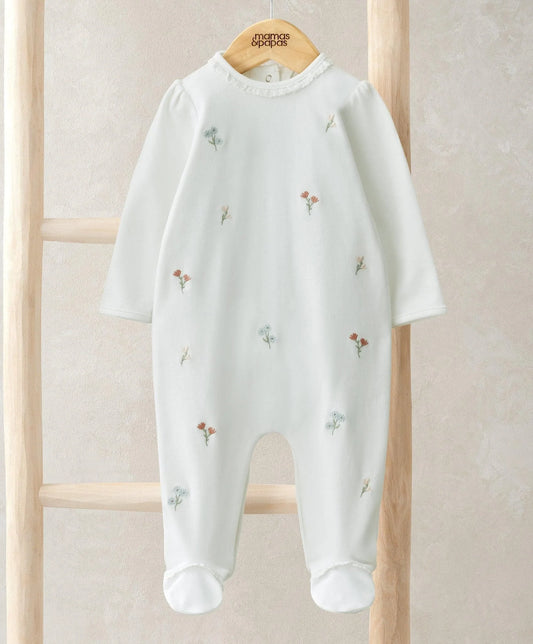 White long-sleeve footed romper with scattered flower embroidery, round neckline