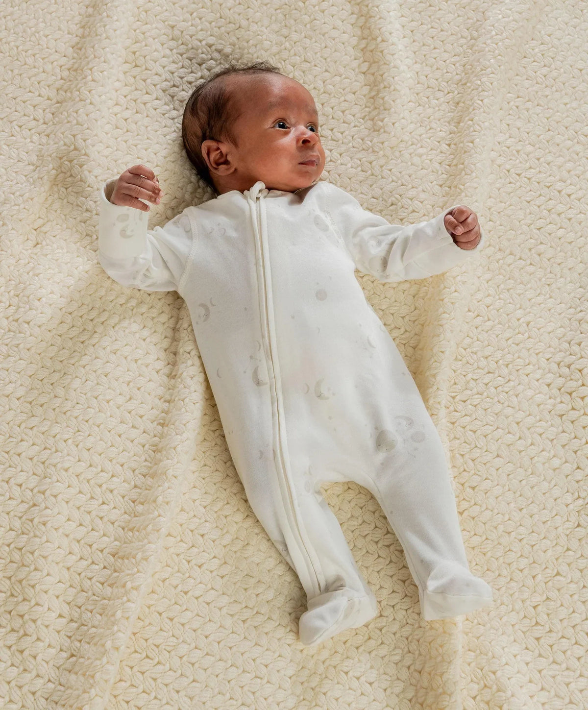 Baby zip-front all-in-one romper with celestial print, long sleeves, white