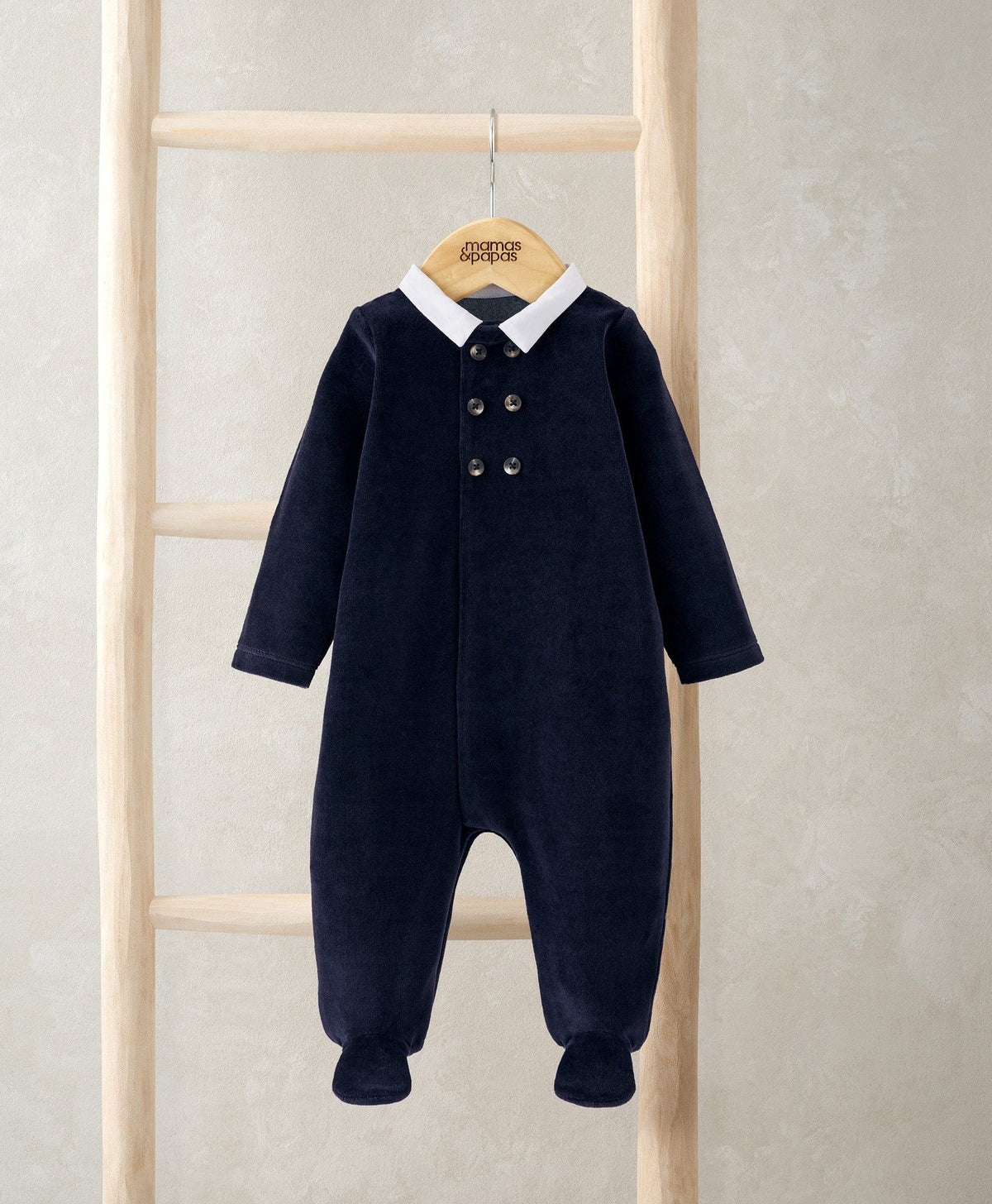 Navy velour sleepsuit with white Peter Pan collar and front button placket