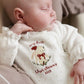 Cream baby bunny Christmas onesie with embroidered bunny and text on chest