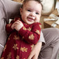 Baby all-in-one romper in dark red with gingerbread cookie print, long sleeves