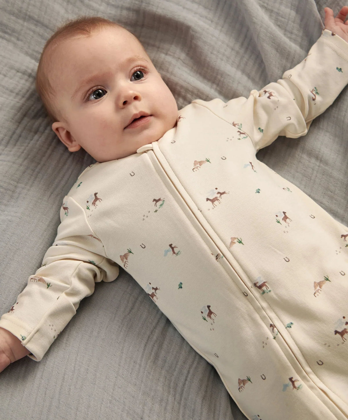 Off-white baby zip sleepsuit with long sleeves, allover small animal print, footed legs