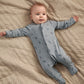 Blue knit footed sleepsuit with zipper and allover Western-style icons.