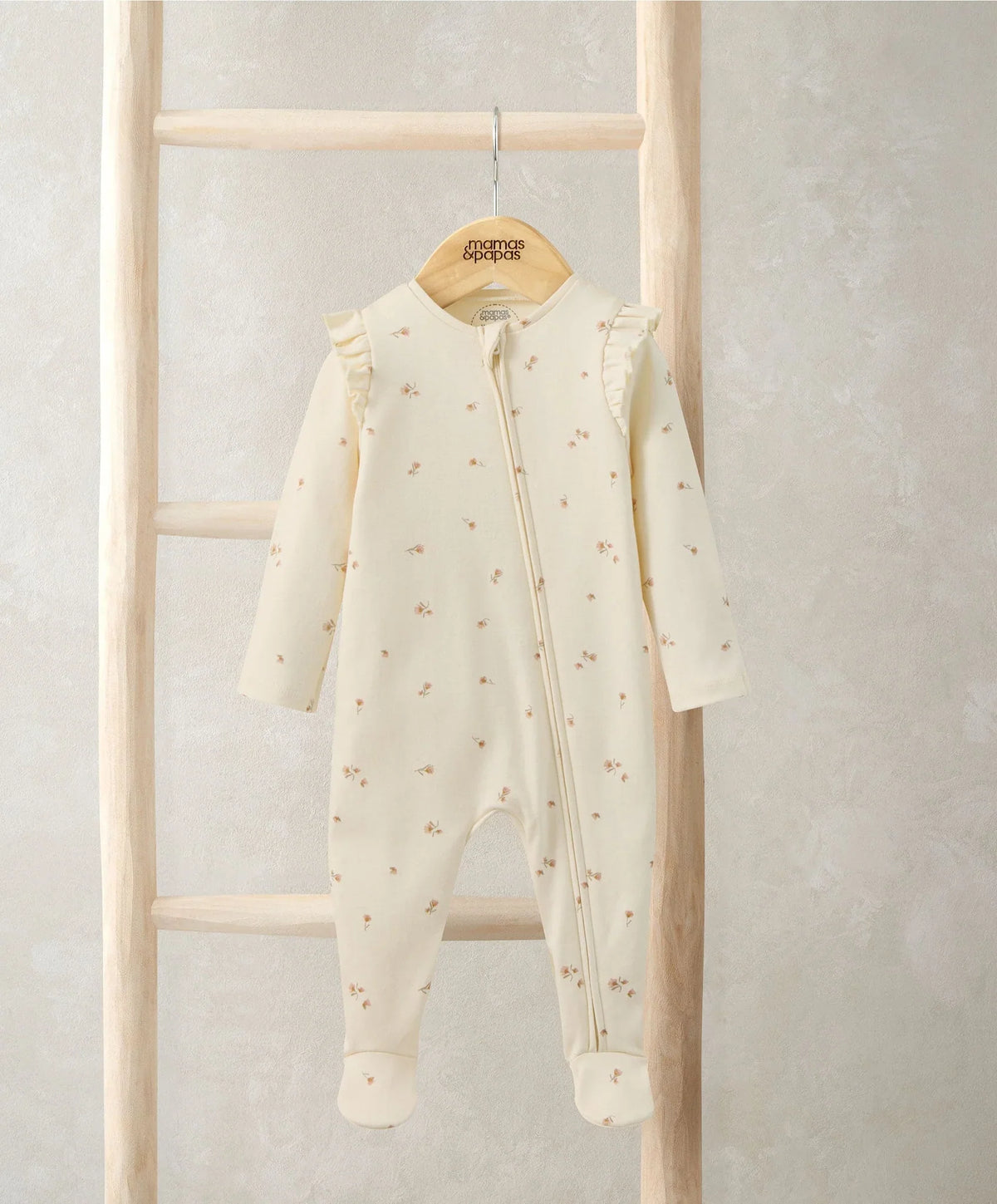 Cream floral zip sleepsuit with long sleeves, footed legs, and front zipper