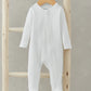 White ribbed organic cotton sleepsuit with footed legs and long sleeves