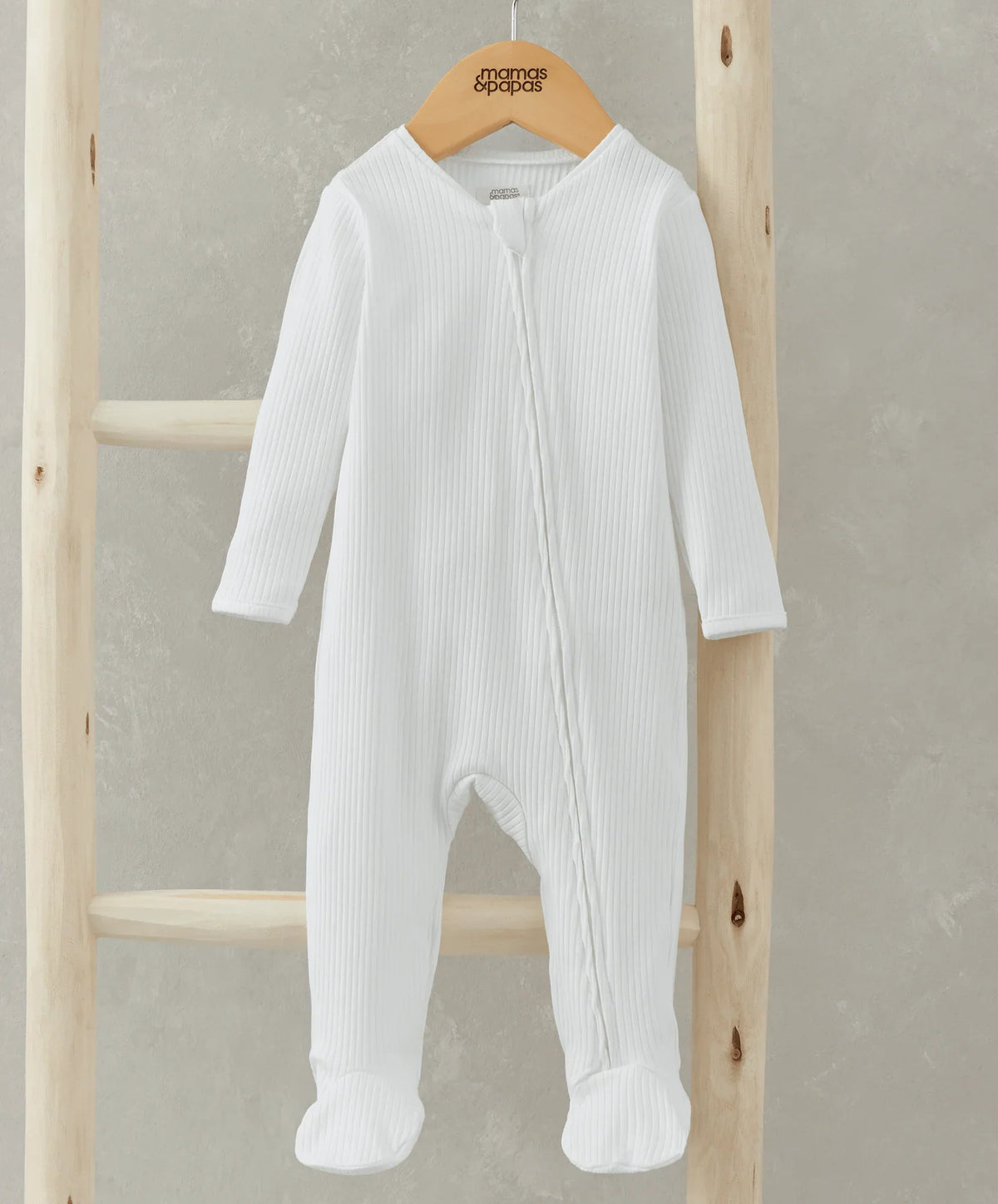 White ribbed organic cotton sleepsuit with footed legs and long sleeves