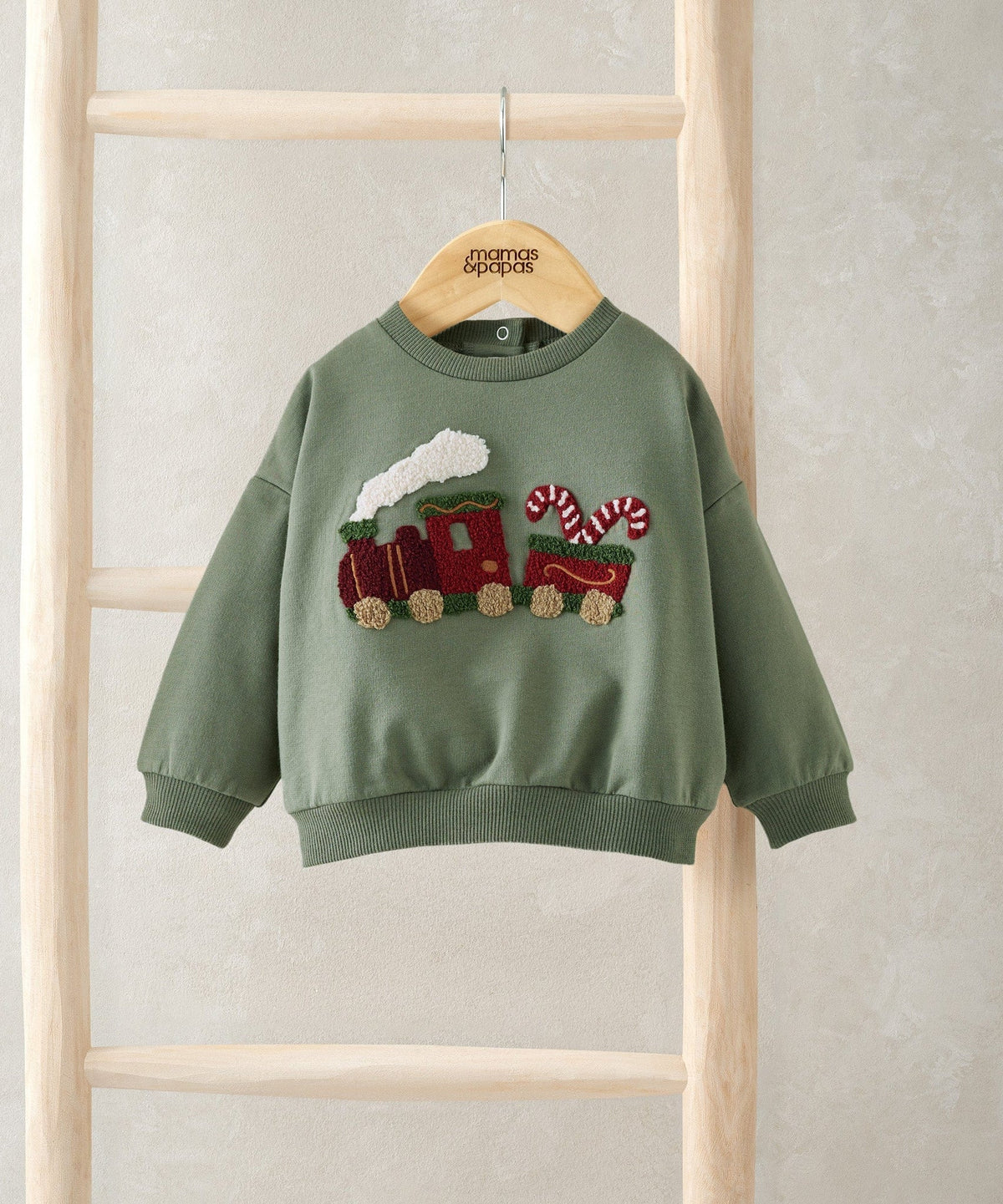 Green Christmas train jumper, full front view, crew neck and appliqué train graphic