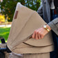 Baby stroller canopy side panel and armrest, light beige fabric.