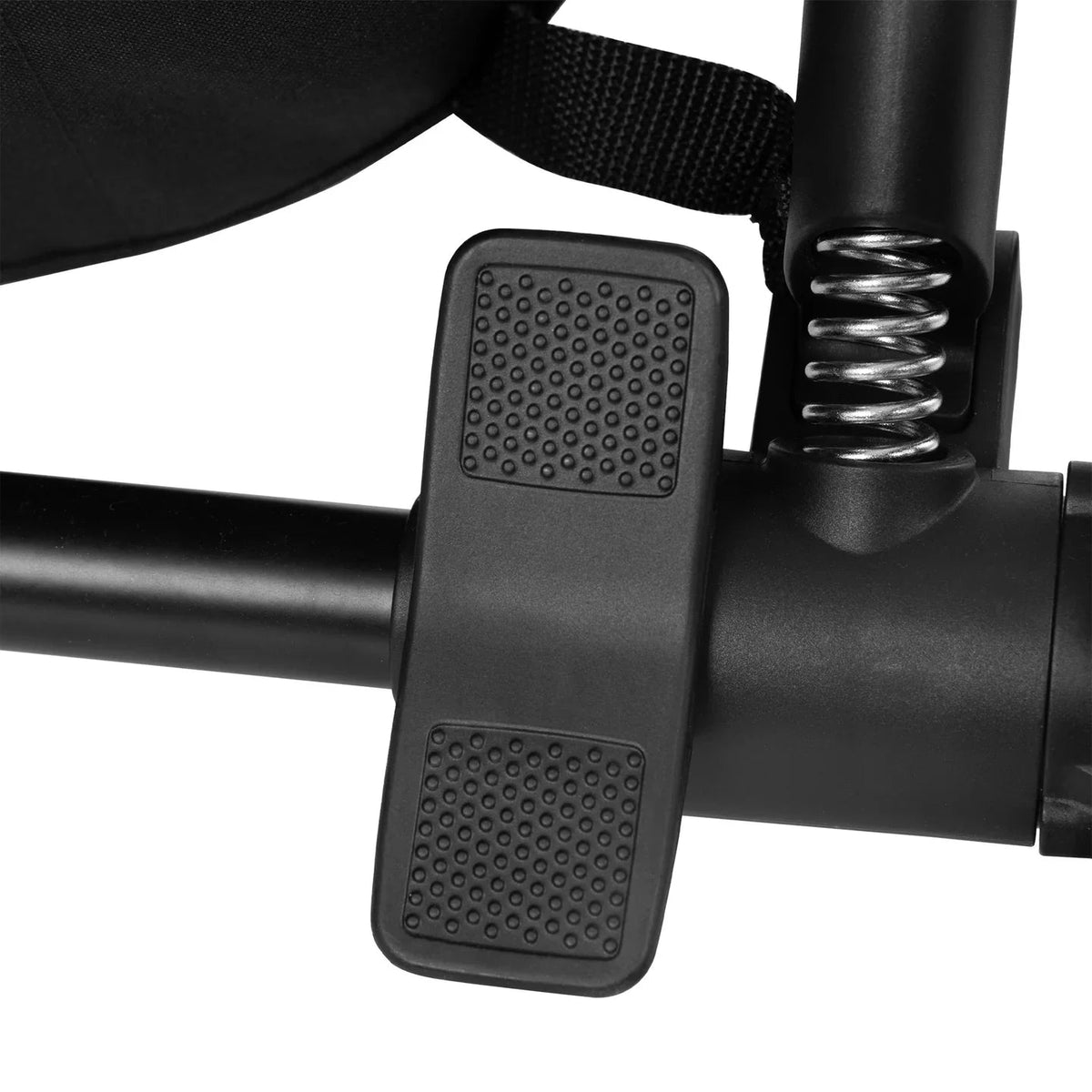 Black stroller accessory with textured foot pedal pads, close-up