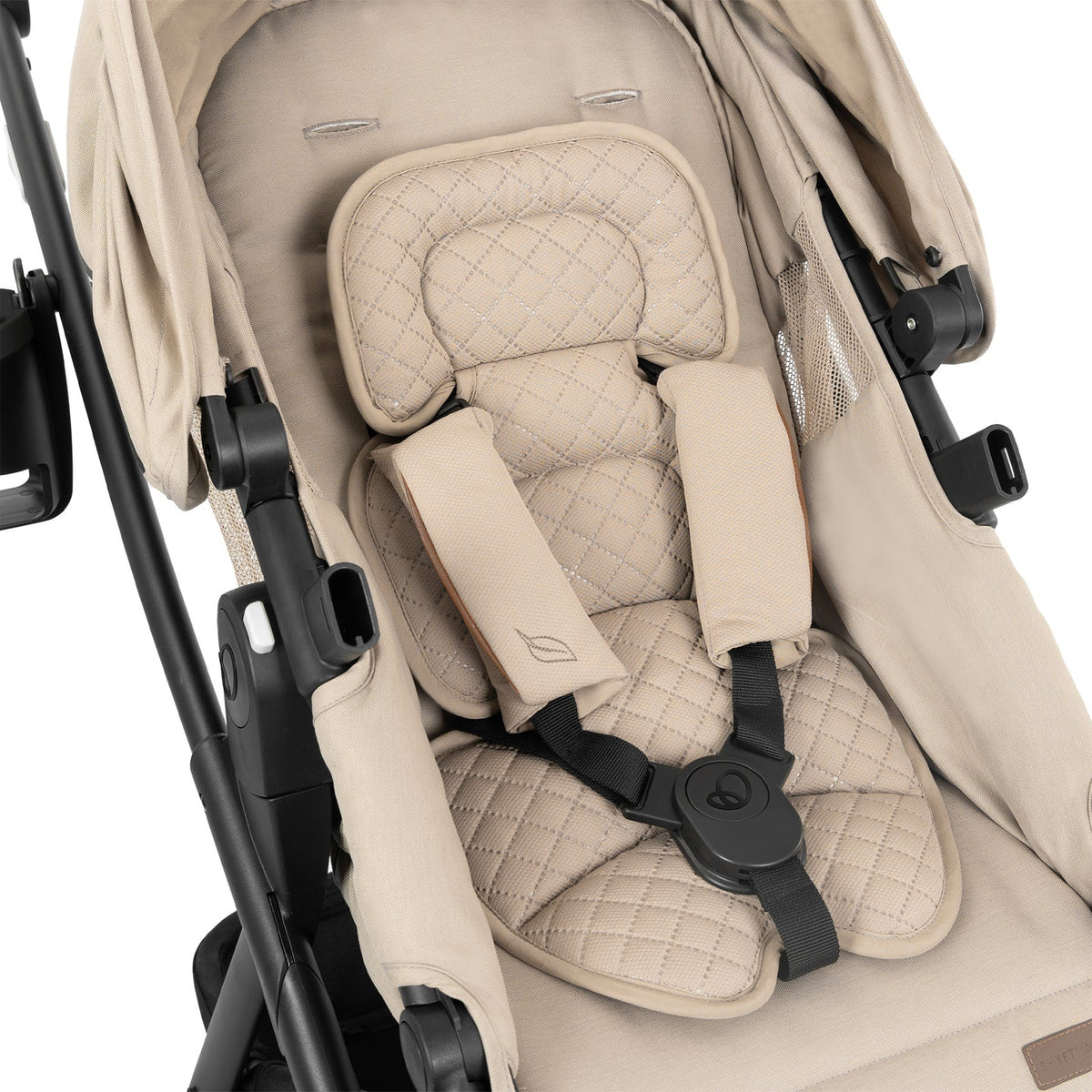 Beige stroller seat with quilted padding and harness buckle detail.