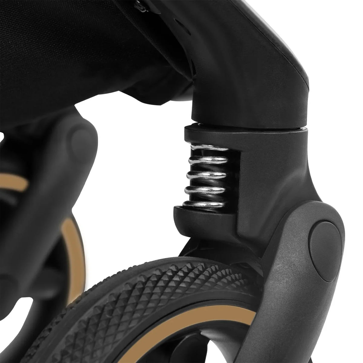 Black stroller suspension joint with metal spring detail, close-up