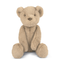 Beige teddy bear soft toy sitting upright with stitched nose and smiling mouth
