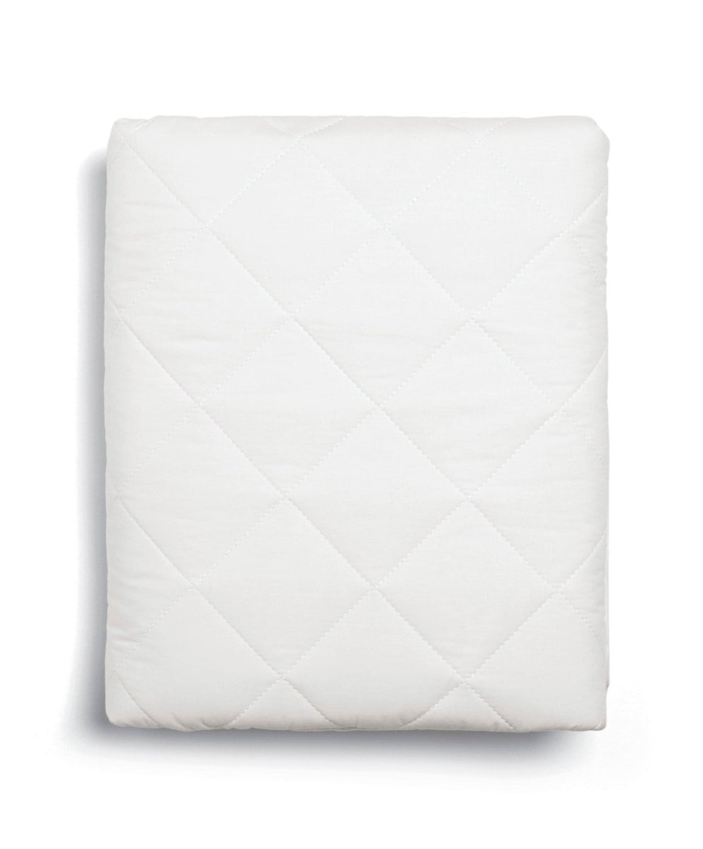 White quilted cotbed mattress protector with diamond stitched pattern