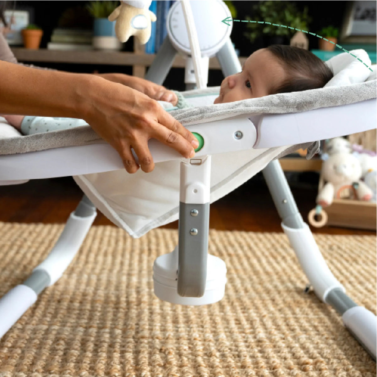 Baby swing frame with control panel and seat support legs on carpet