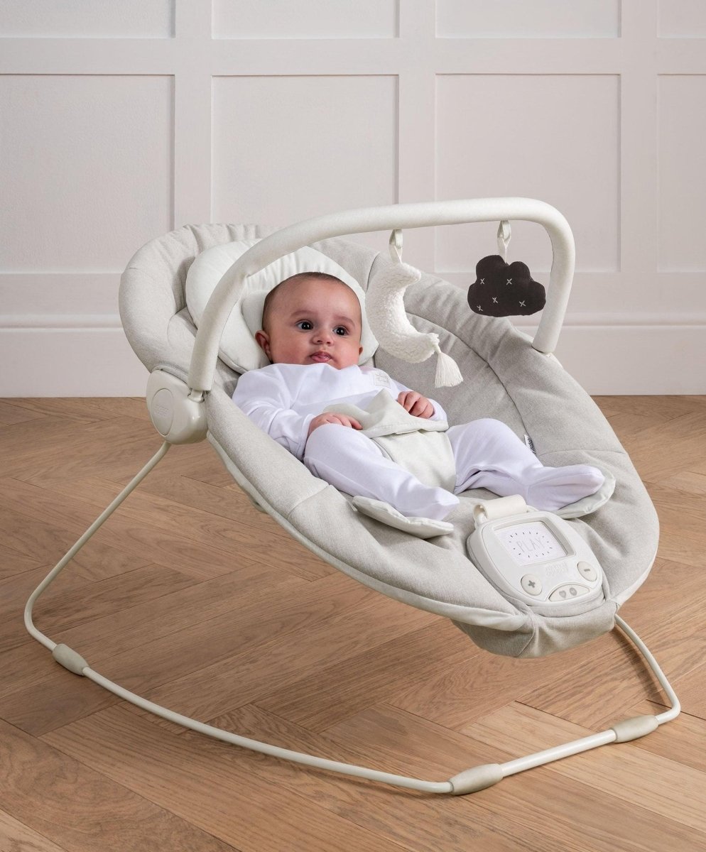 Baby swing bouncer with light gray fabric, arch frame, and hanging cloud toy