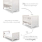 White cotbed with vertical slats, squared end panels, and low base position