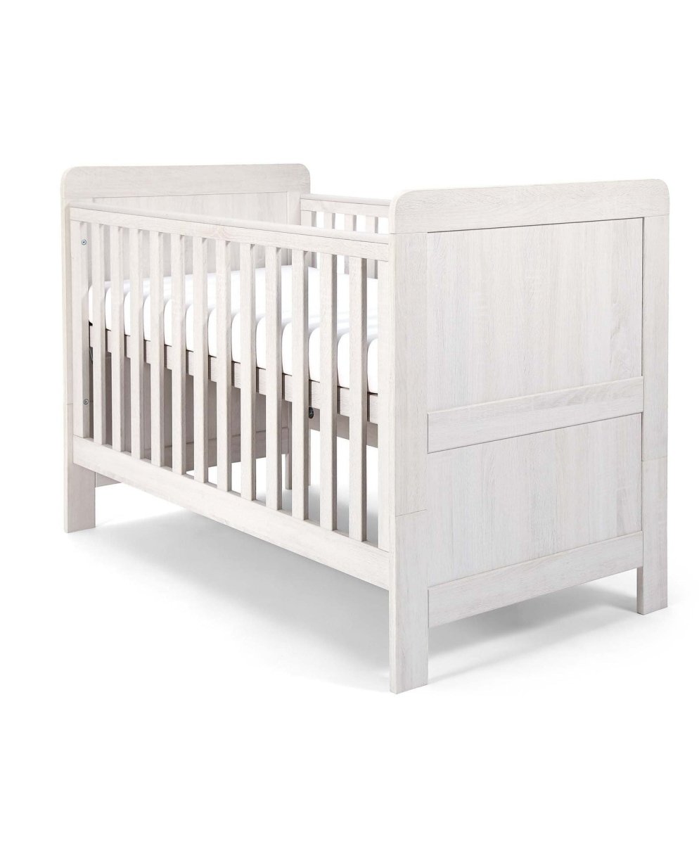 White wood cotbed with vertical slats and two end panels, front three-quarter view