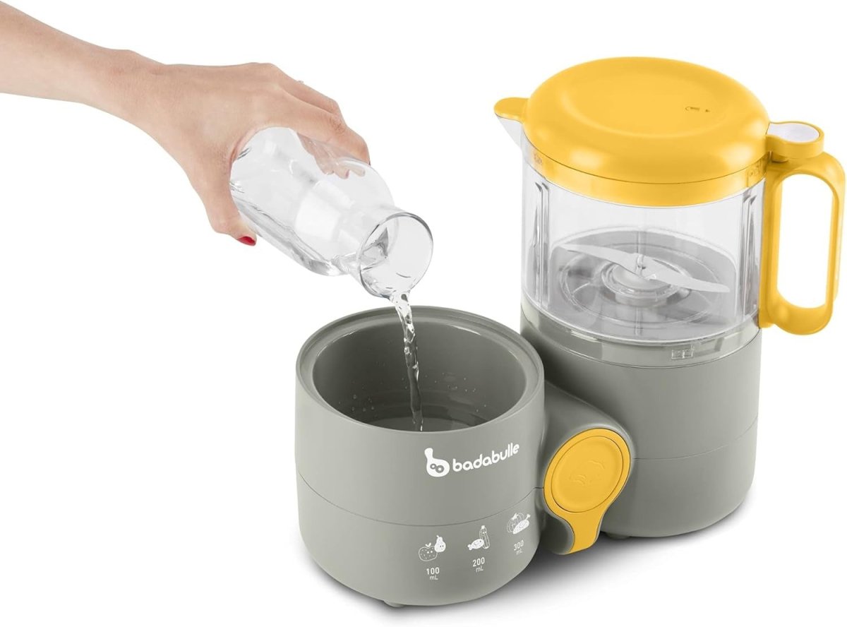 Gray baby food processor base with yellow-lidded steamer jar and pour-through spout