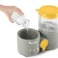Gray baby food processor base with yellow-lidded steamer jar and water being poured in