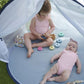 Pop-up baby tent interior with light gray floor and mesh canopy