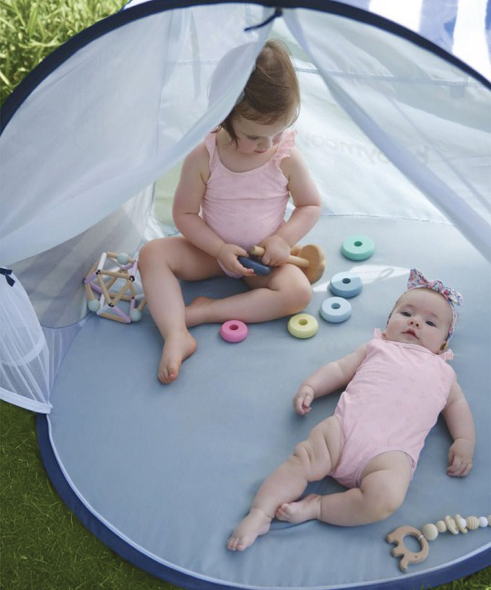 Pop-up baby tent interior with light gray floor and mesh canopy