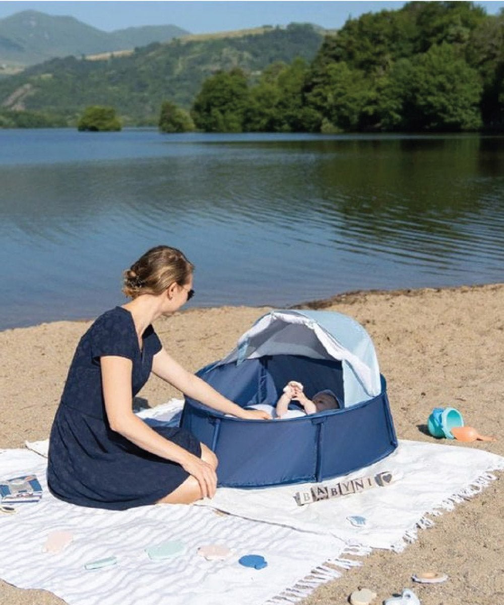Navy baby pop-up play tent with open mesh canopy and baby inside