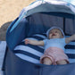 Baby lying inside navy pop-up play tent with striped liner and open mesh roof