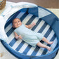 Blue-and-white striped play mat inside navy pop-up tent with open mesh sides