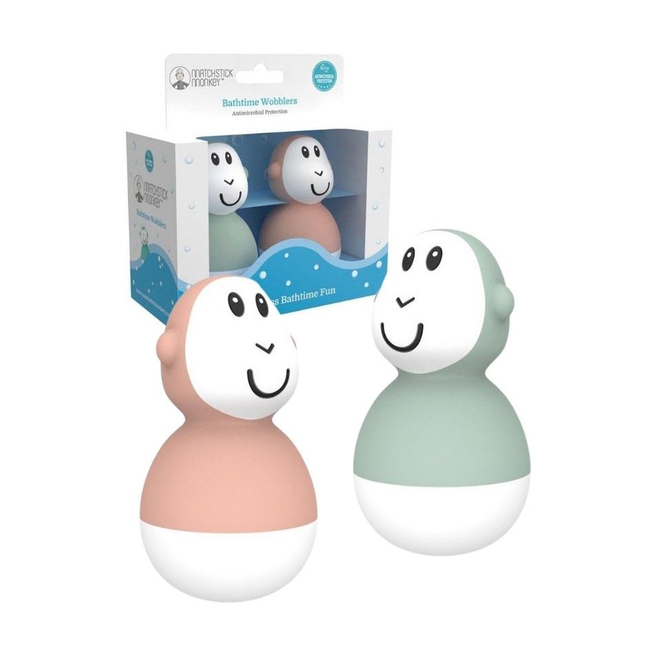 Pack of 2 bath wobbler toys in mint and peach, with smiling faces and rounded bodies.