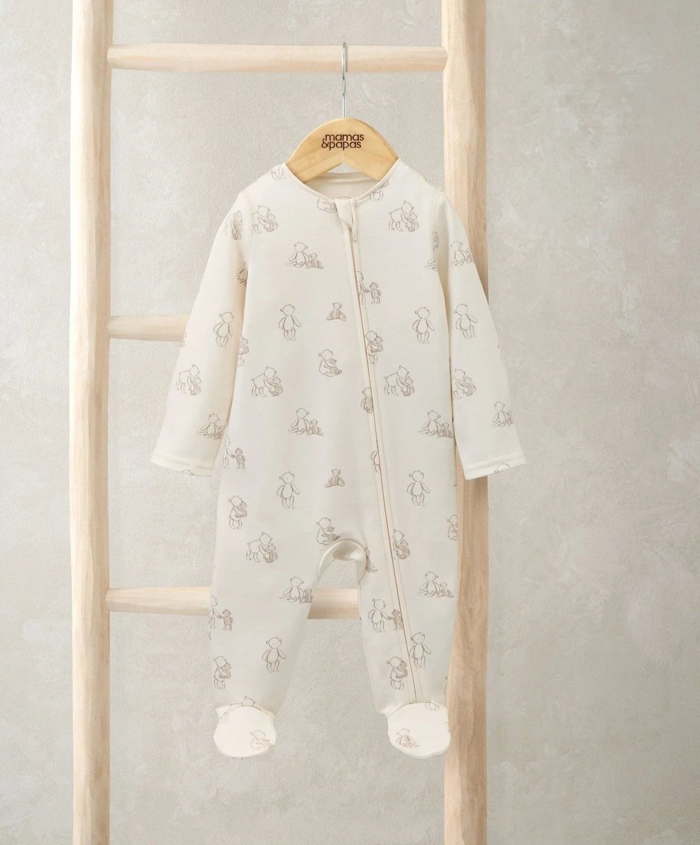 Cream bear-print all-in-one with front zip, long sleeves, footed cuffs
