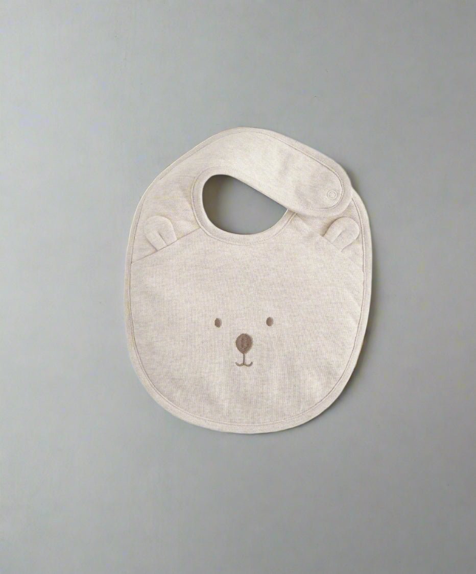 Light beige bear-face bib with oval neck opening