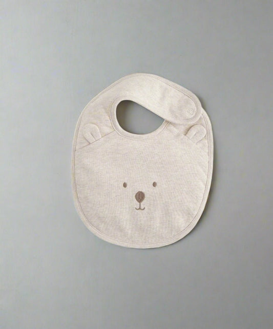 Light beige bear-face bib with oval neck opening