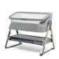 Grey bedside crib with fabric frame, open side and bassinet surface