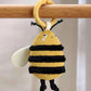 Hanging bee activity soft toy with yellow and black striped body, plush wings