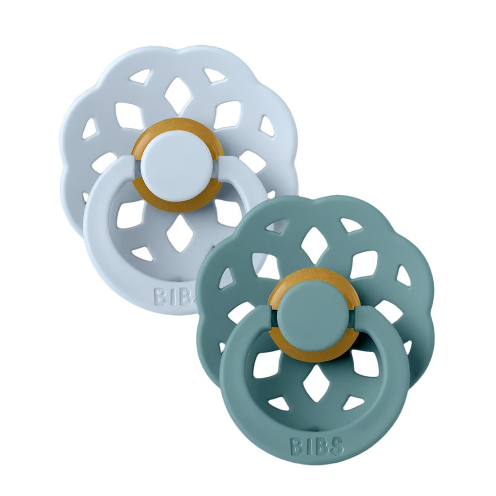 Pair of BIBS flower pacifiers in light blue and teal, with gold center rings